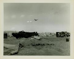 Photograph, Supply plane parachuting supplies over the beach at Iwo Jima