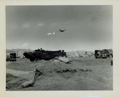 Photograph, Supply plane parachuting supplies over the beach at Iwo Jima