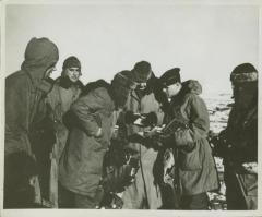 Photograph, Major Hauenstein inspecting code book, Iceland